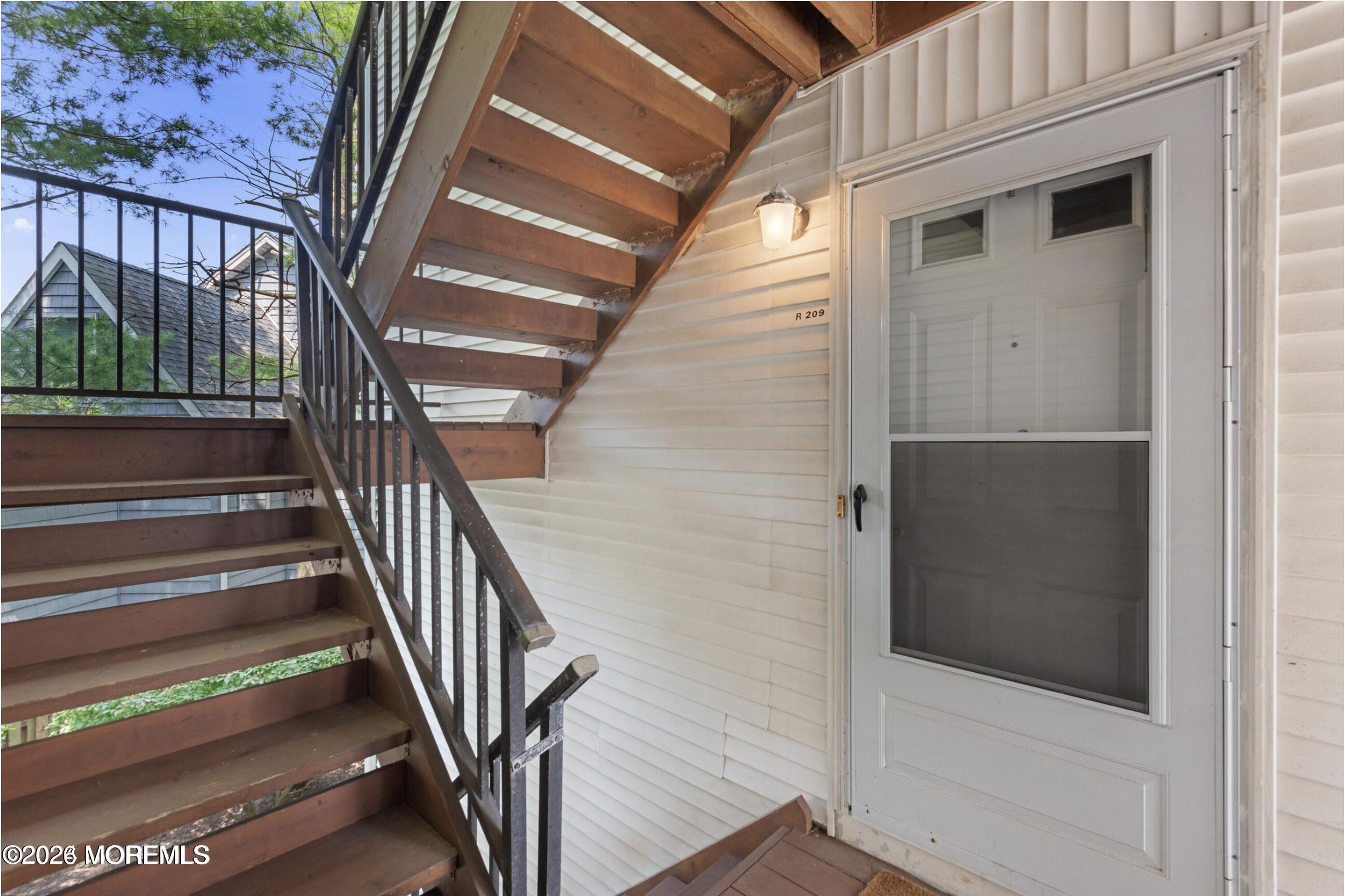 1606 Main Street, Unit R209 Lake Como, NJ 07719 - Photo 4 of 26 a view of staircase with railing and white walls