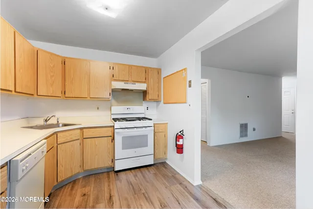 a kitchen with granite countertop a sink and a stove top oven