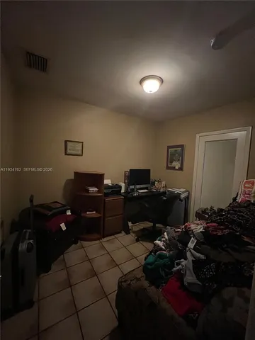 a living room with furniture and a piano