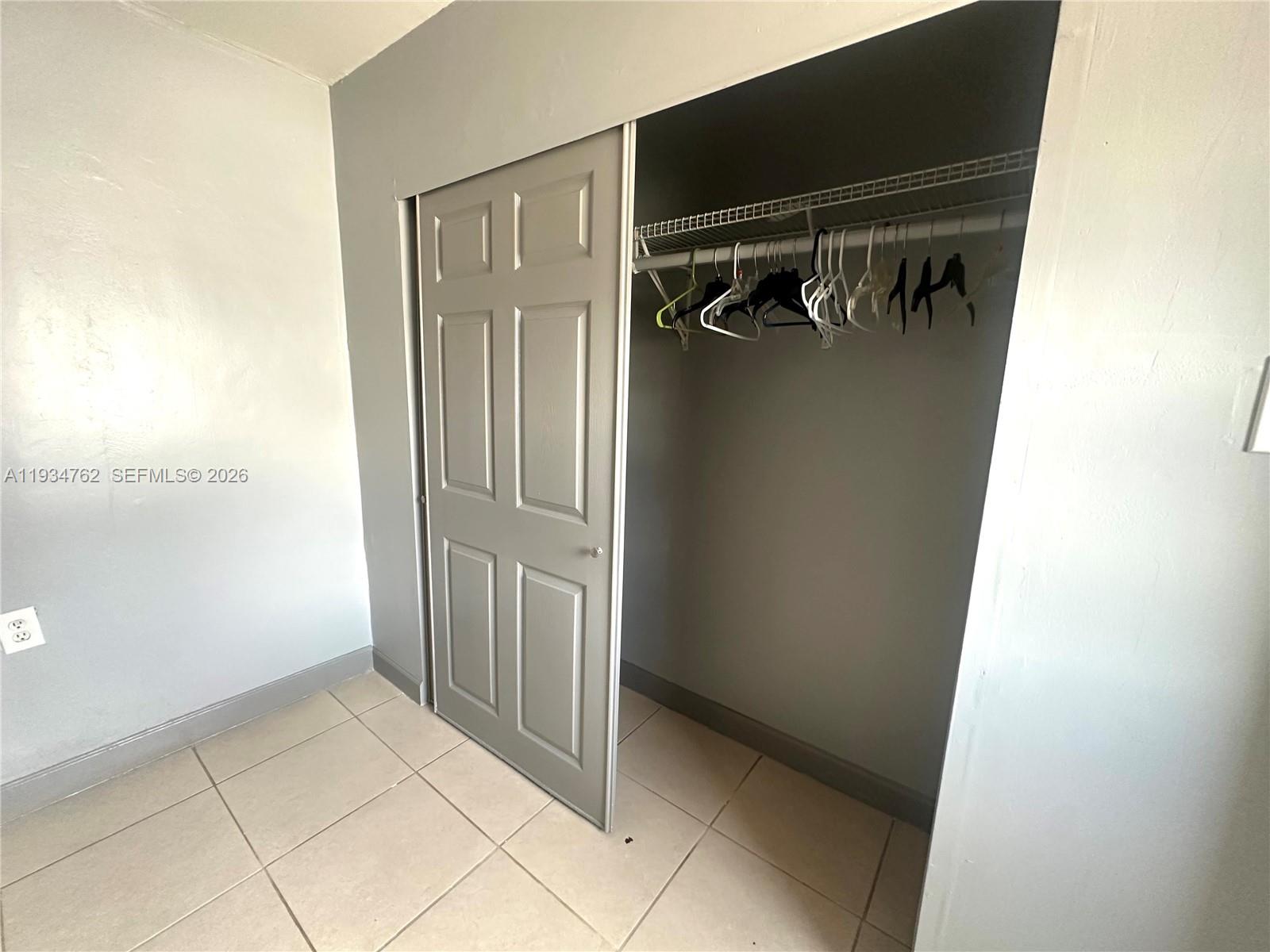 4361 Southwest 3rd Street Miami, FL 33134 - Photo 21 of 24 a view of walk in closet with clothes and shoes