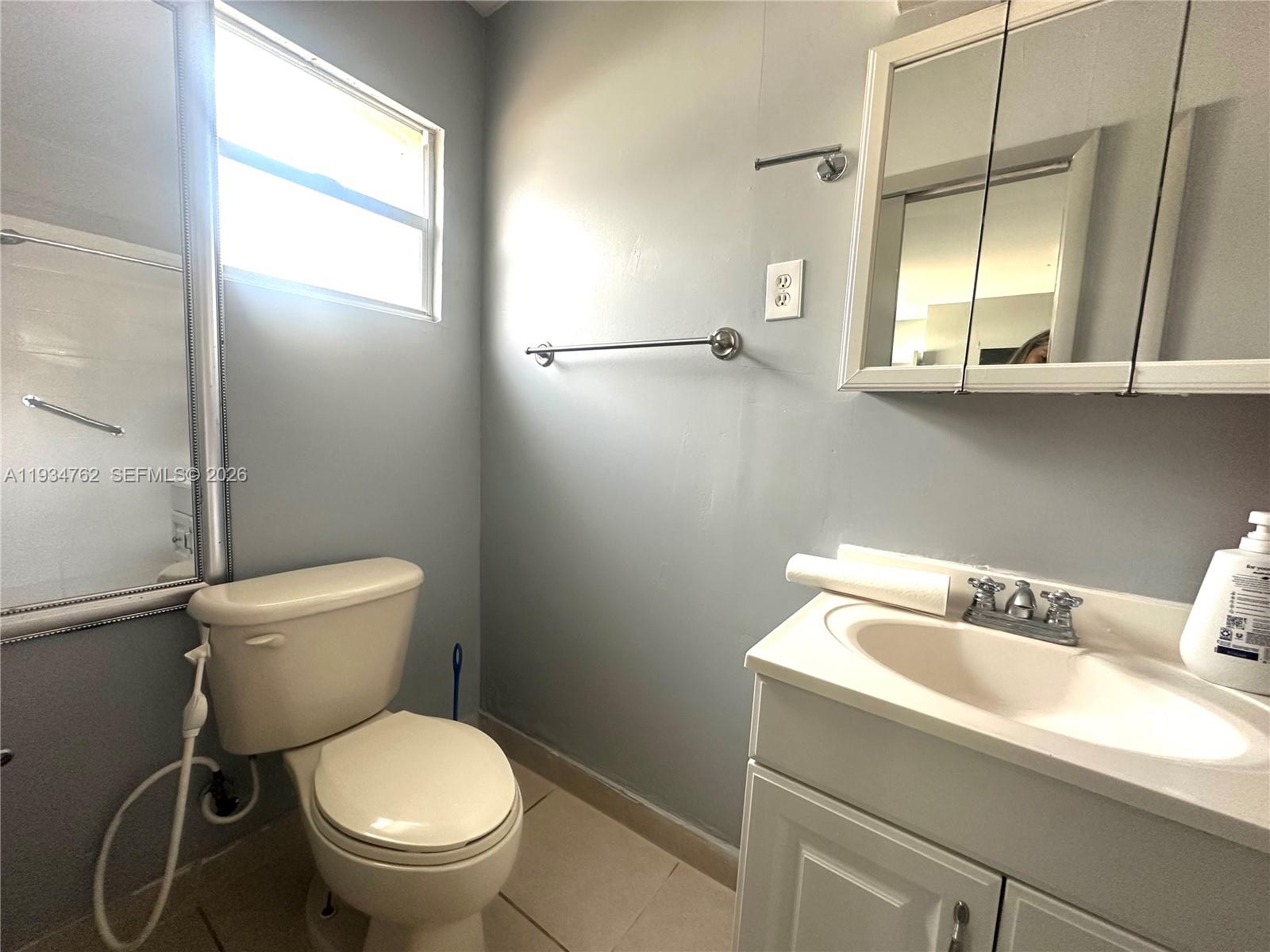 4361 Southwest 3rd Street Miami, FL 33134 - Photo 23 of 24 a white toilet sitting next to a bathroom sink