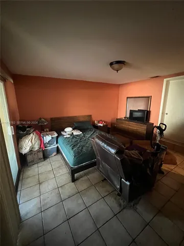 a bedroom with furniture and a mirror