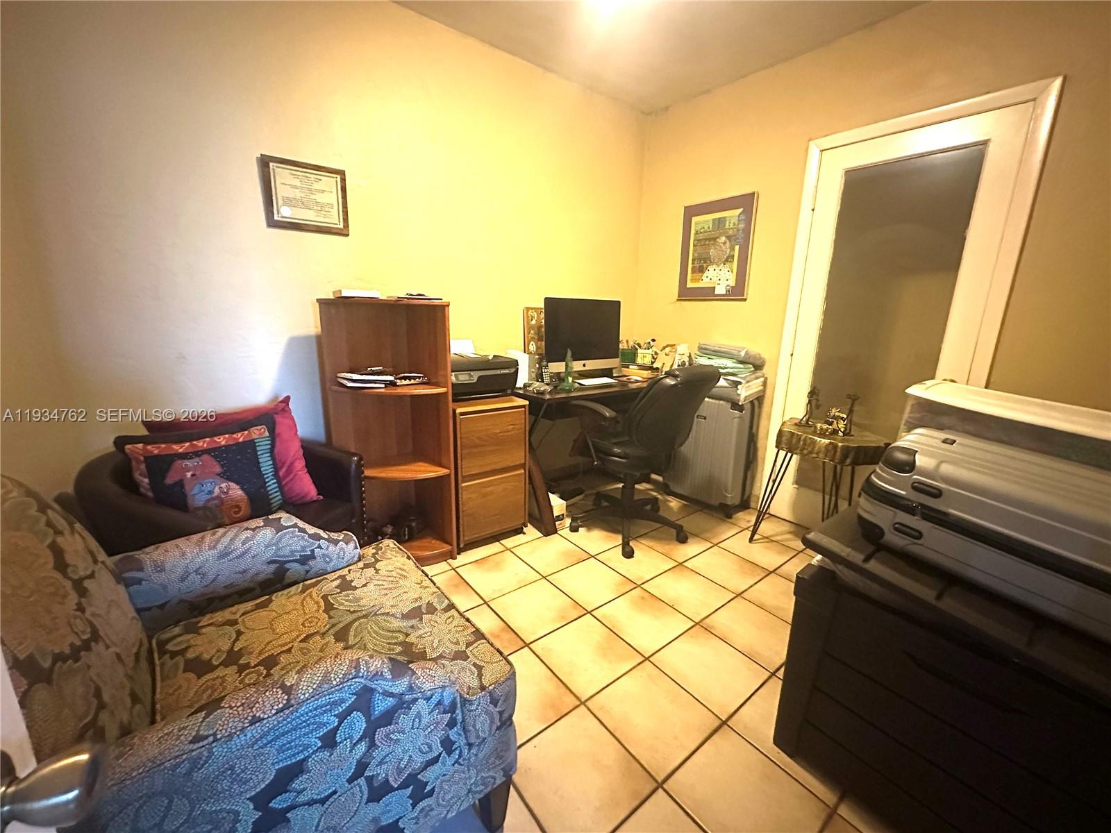 4361 Southwest 3rd Street Miami, FL 33134 - Photo 8 of 24 a living room with furniture and a computer on a table