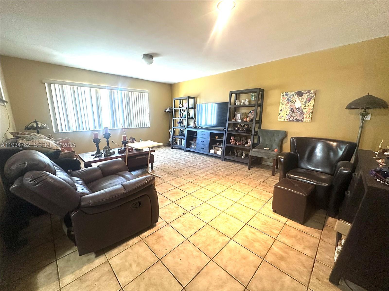 4361 Southwest 3rd Street Miami, FL 33134 - Photo 9 of 24 a living room with furniture and a flat screen tv