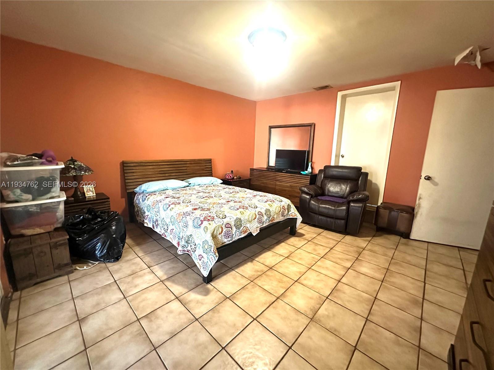 4361 Southwest 3rd Street Miami, FL 33134 - Photo 10 of 24 a bedroom with a bed and dresser with mirror