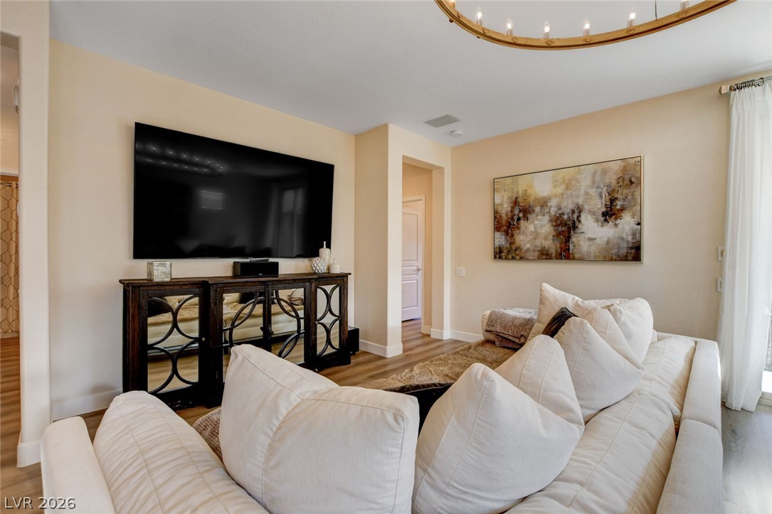 2649 Rue Marquette Avenue Henderson, NV 89044 - Photo 11 of 55 This generous living room features sleek flooring and a large wall-mounted screen for entertainment.