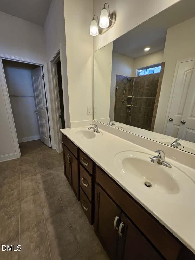 4305 Sir Julian Court Raleigh, NC 27610 - Photo 12 of 25 a bathroom with a double vanity sink a and mirror