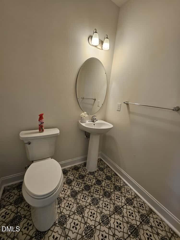 4305 Sir Julian Court Raleigh, NC 27610 - Photo 15 of 25 a bathroom with a toilet a sink and a mirror