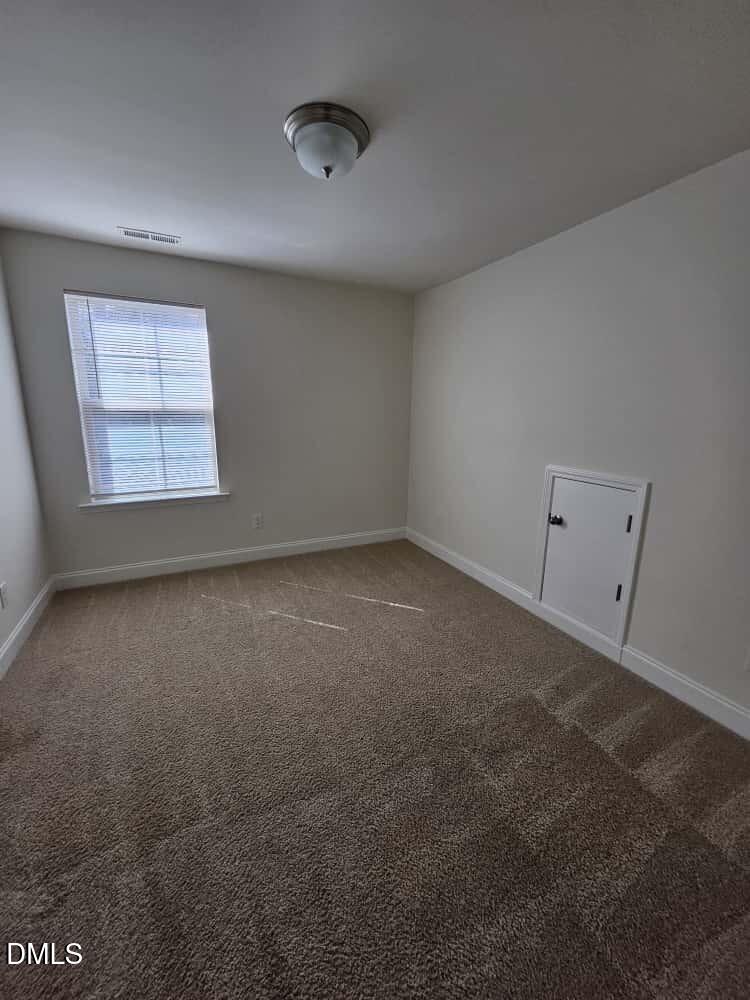 4305 Sir Julian Court Raleigh, NC 27610 - Photo 18 of 25 an empty room with a window