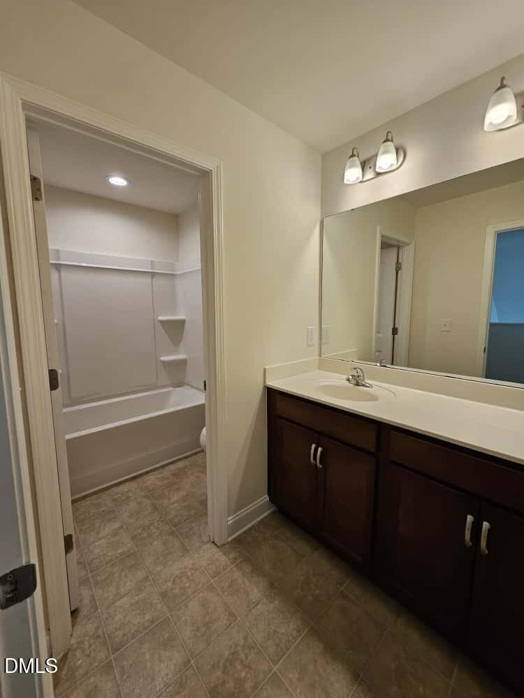 4305 Sir Julian Court Raleigh, NC 27610 - Photo 22 of 25 a bathroom with a double vanity sink a mirror and a shower