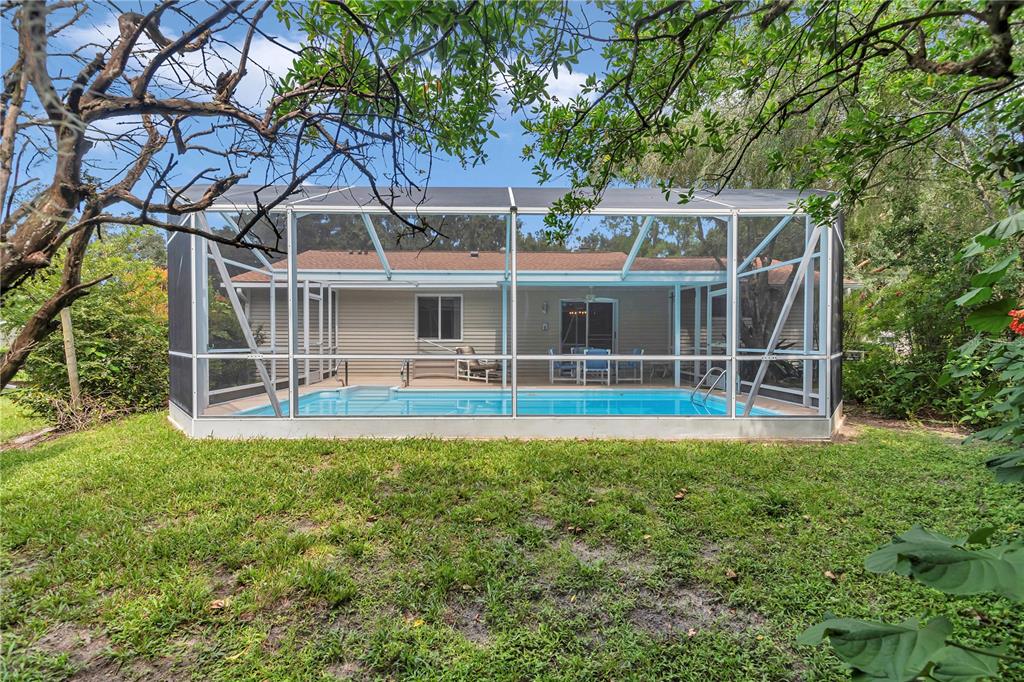 8012 Southwest 109th Place Road Ocala, FL 34481 - Photo 17 of 20 a view of house with a big yard and large trees