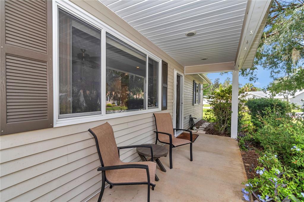 8012 Southwest 109th Place Road Ocala, FL 34481 - Photo 3 of 20 a view of a patio with table and chairs and potted plants