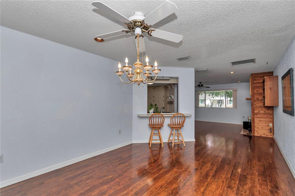8012 Southwest 109th Place Road Ocala, FL 34481 - Photo 5 of 20 a dining room with chandelier wooden floor a chandelier fan a wooden floor and a chandelier