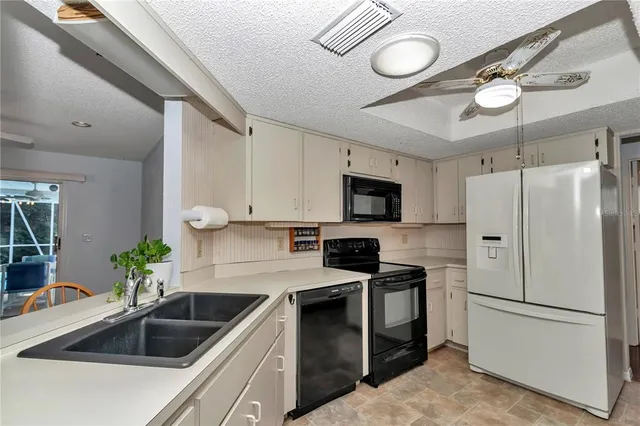 a kitchen with a sink appliances and cabinets