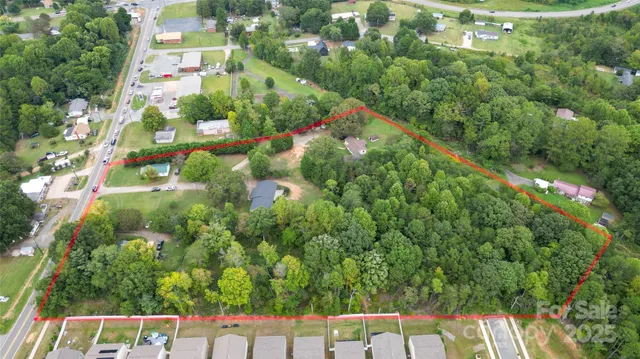 a backyard of a house with lots of green space and two buildings