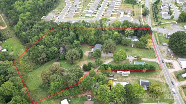 an aerial view of a house with a yard and lake view