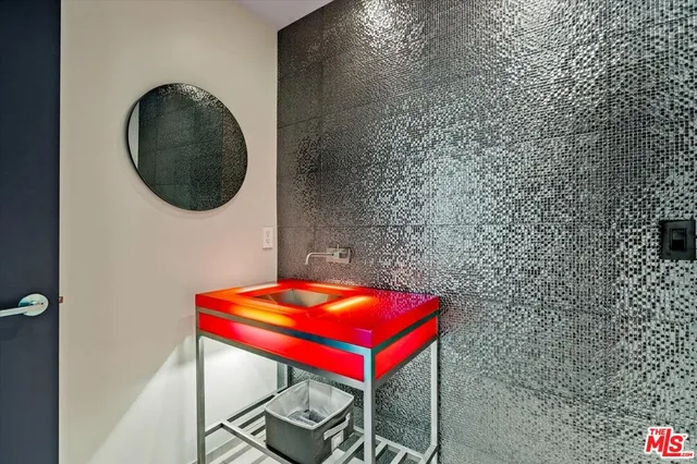 a bathroom with a granite countertop sink mirror and tub