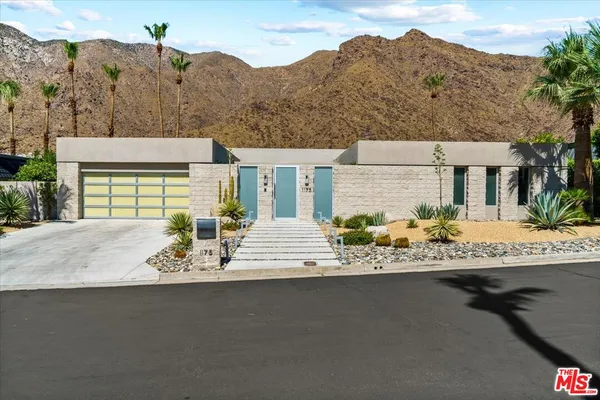 a view of a house with a swimming pool and sitting area