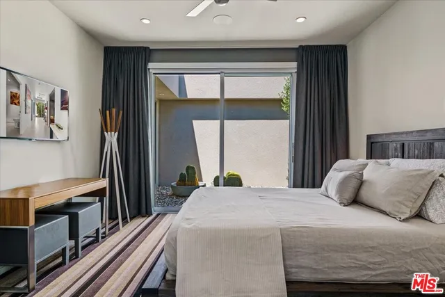 a view of a backyard with plants and a garage