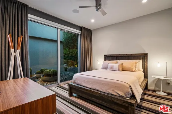 a living room with fireplace furniture and a large window