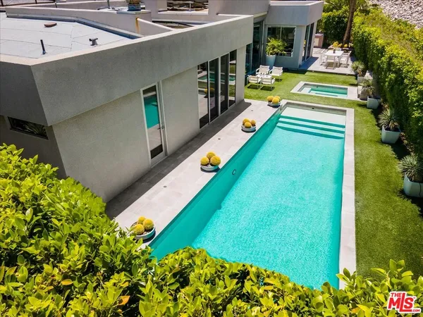 a view of a house with backyard sitting area and garden