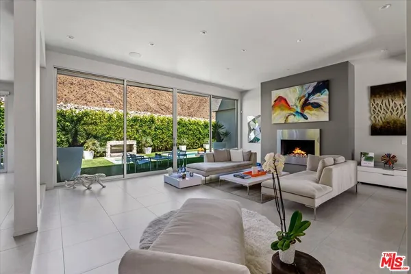 a living room with furniture fireplace and flat screen tv