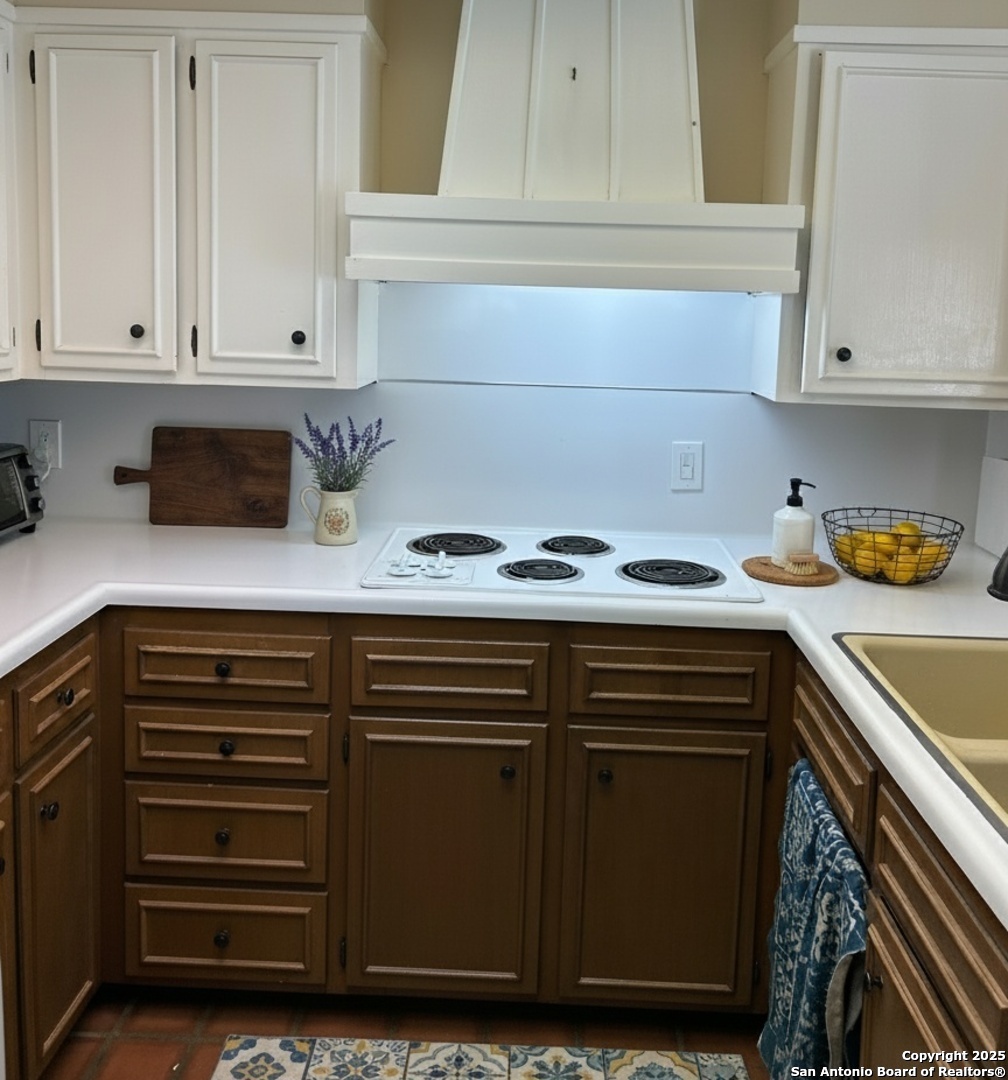 425 Golfcrest Drive Windcrest, TX 78239 - Photo 12 of 26 a kitchen with granite countertop a sink and cabinets
