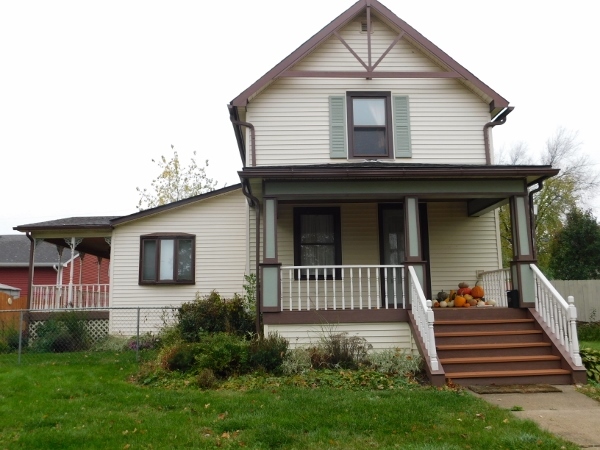 a view of a house with brick walls and a yard