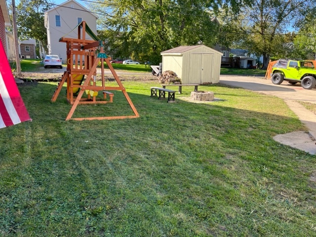 606 North 3rd Street Rochelle, IL 61068 - Photo 34 of 36 a view of playground with a slide and large trees