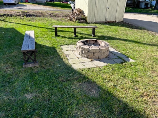 606 North 3rd Street Rochelle, IL 61068 - Photo 36 of 36 a white bench sitting in the grass near a house