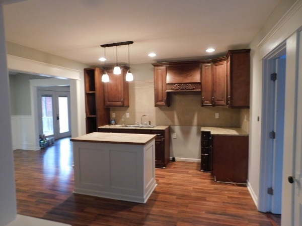606 North 3rd Street Rochelle, IL 61068 - Photo 6 of 36 a kitchen with kitchen island granite countertop a stove and a wooden floors