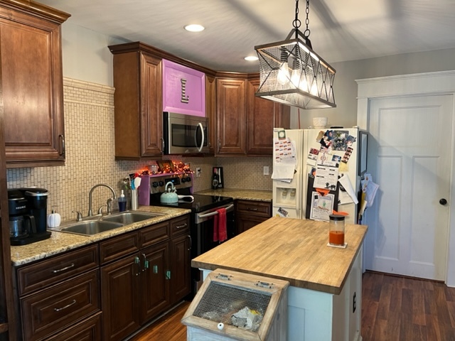 606 North 3rd Street Rochelle, IL 61068 - Photo 8 of 36 a kitchen with stainless steel appliances kitchen island granite countertop a sink stove and refrigerator