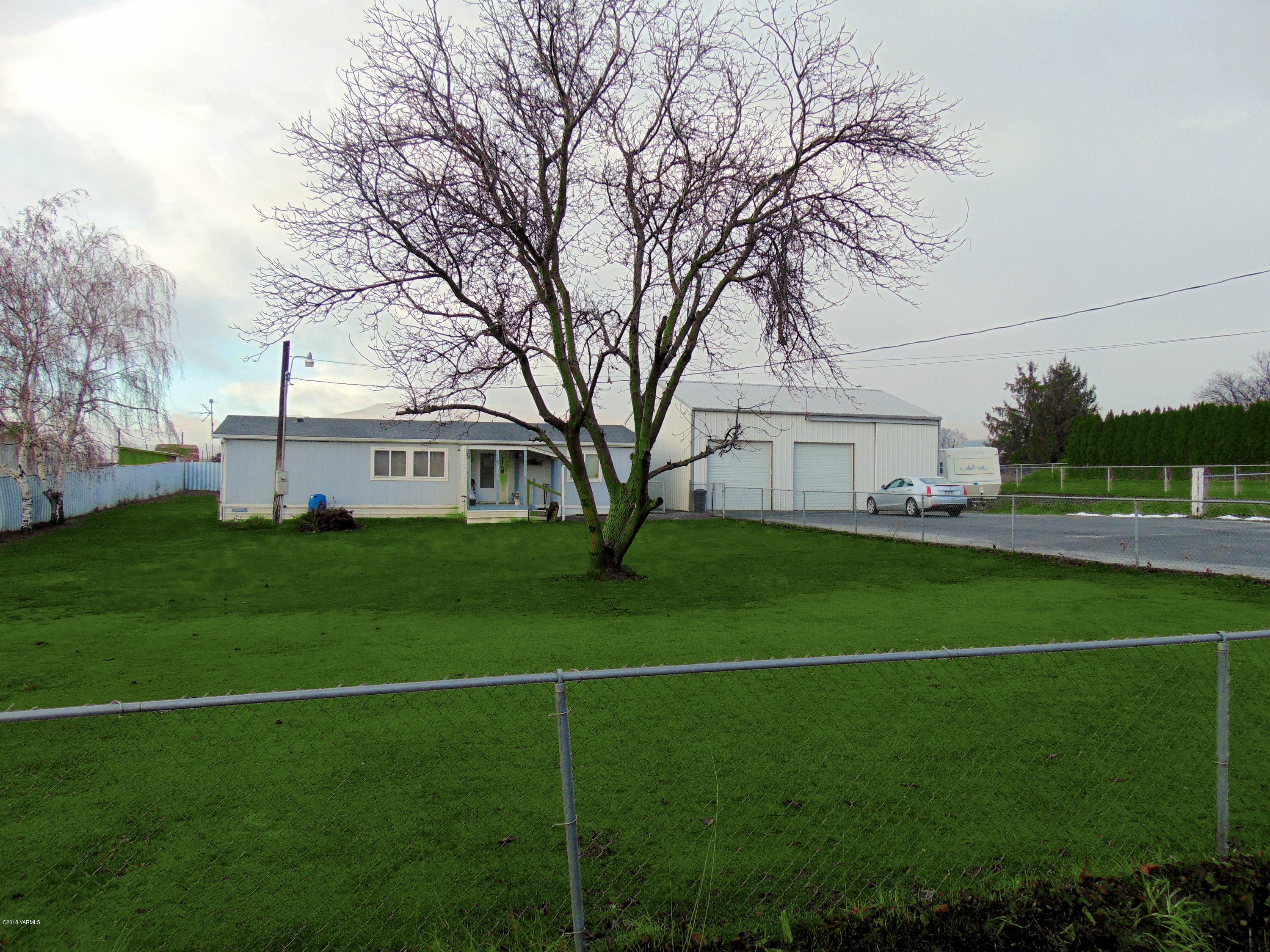 7001 Mieras Road Yakima, WA 98901 - Photo 1 of 5 a front view of a house with a garden