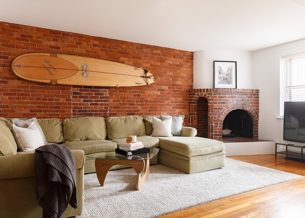 193 St Botolph Street, Unit 1 Boston, MA 02115 - Photo 3 of 15 a living room with furniture and a fireplace