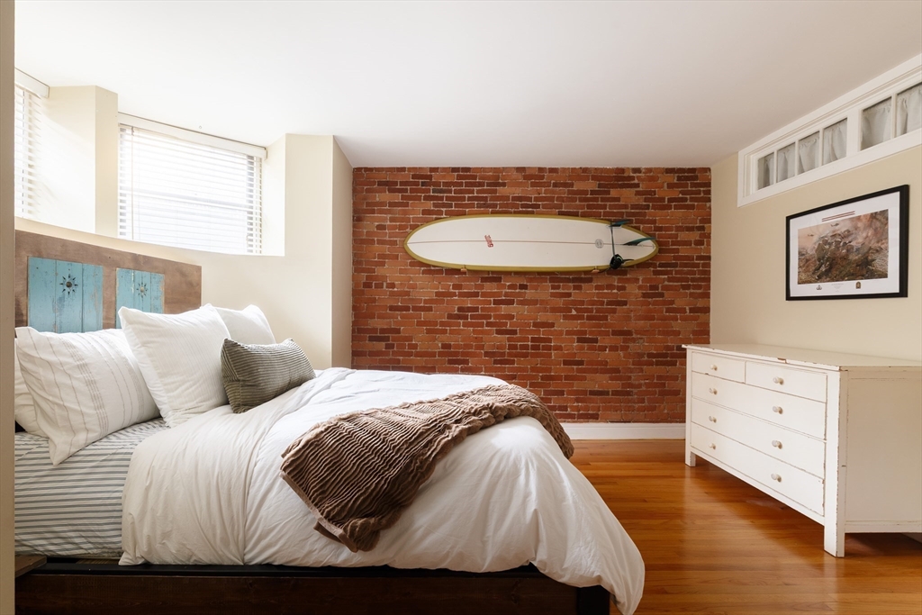 193 St Botolph Street, Unit 1 Boston, MA 02115 - Photo 6 of 15 a bedroom with a bed and wooden floor