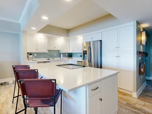 a kitchen with a sink a stove and cabinets