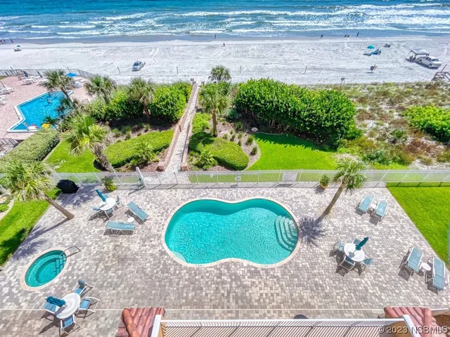 a view of a swimming pool with a yard