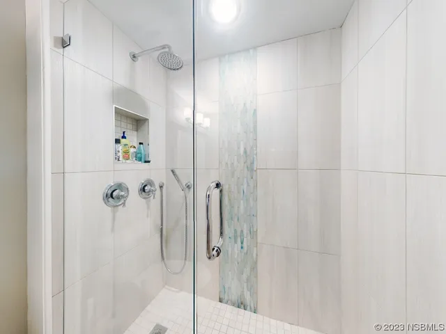 a bedroom with a bed and chandelier