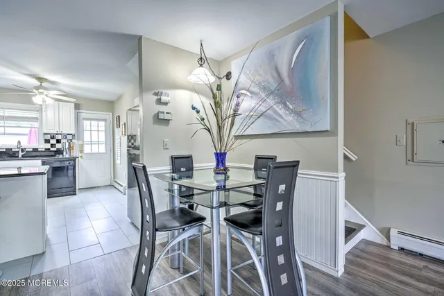 a view of a dining room with furniture and chandelier