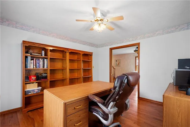 a view of a workspace with furniture and wooden floor