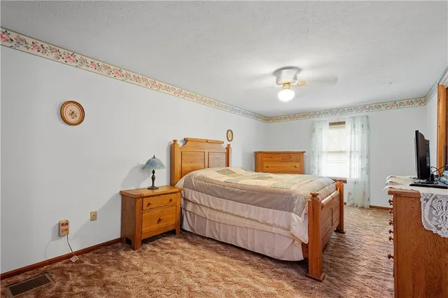 a bedroom with bed and window