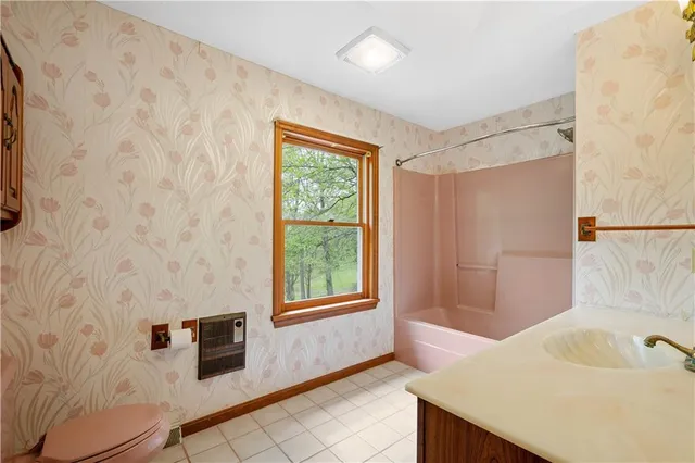 a bathroom with a bathtub and shower