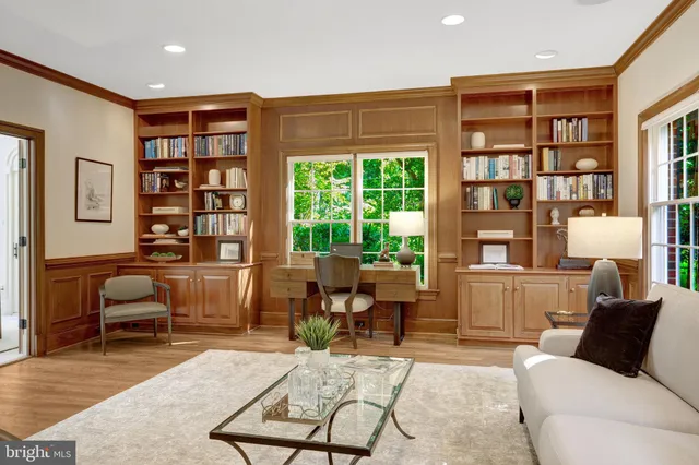 a dining room with furniture a chandelier and wooden floor