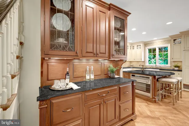 a view of an empty room with wooden floor and window