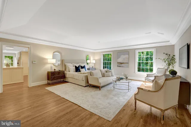 a view of an empty room with wooden floor and staircase