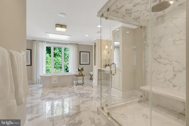 a view of a swimming pool with a patio and wooden fence