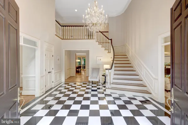 a view of a dining room with furniture and a chandelier