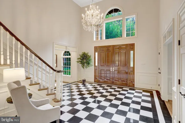a dining room with furniture a chandelier and window