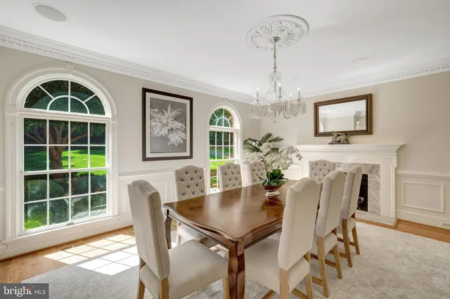 a living room with furniture a fireplace and a large window