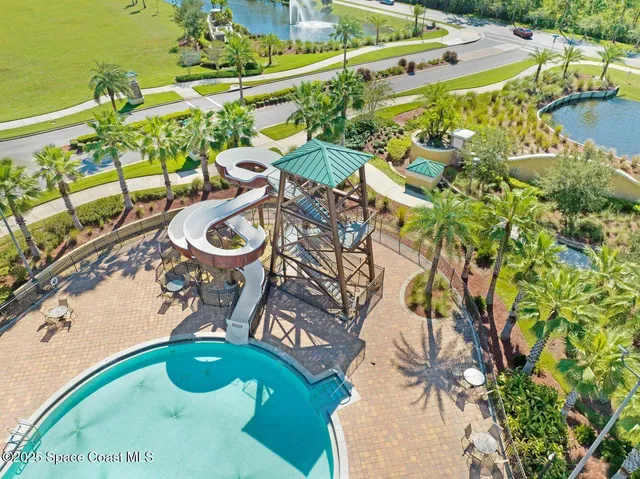 an aerial view of a house with swimming pool and a yard